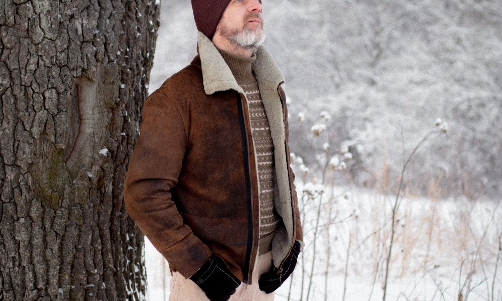 Man in suede coat in the snow