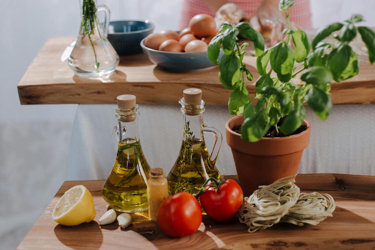 olive oil on counter by herbs