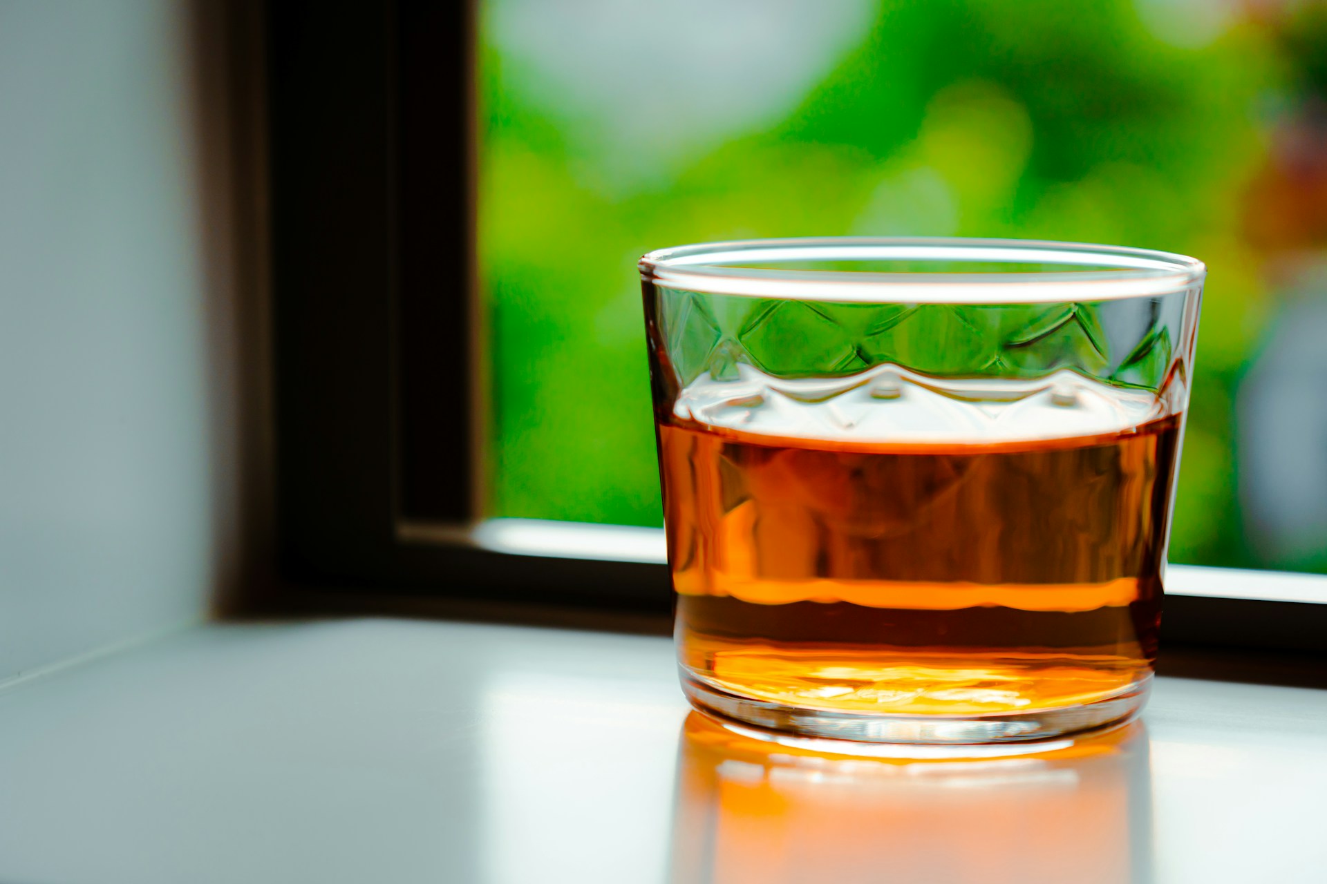 Whiskey in front of a window