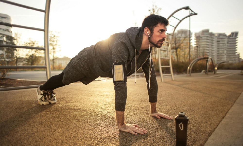 a man in plank pose outside