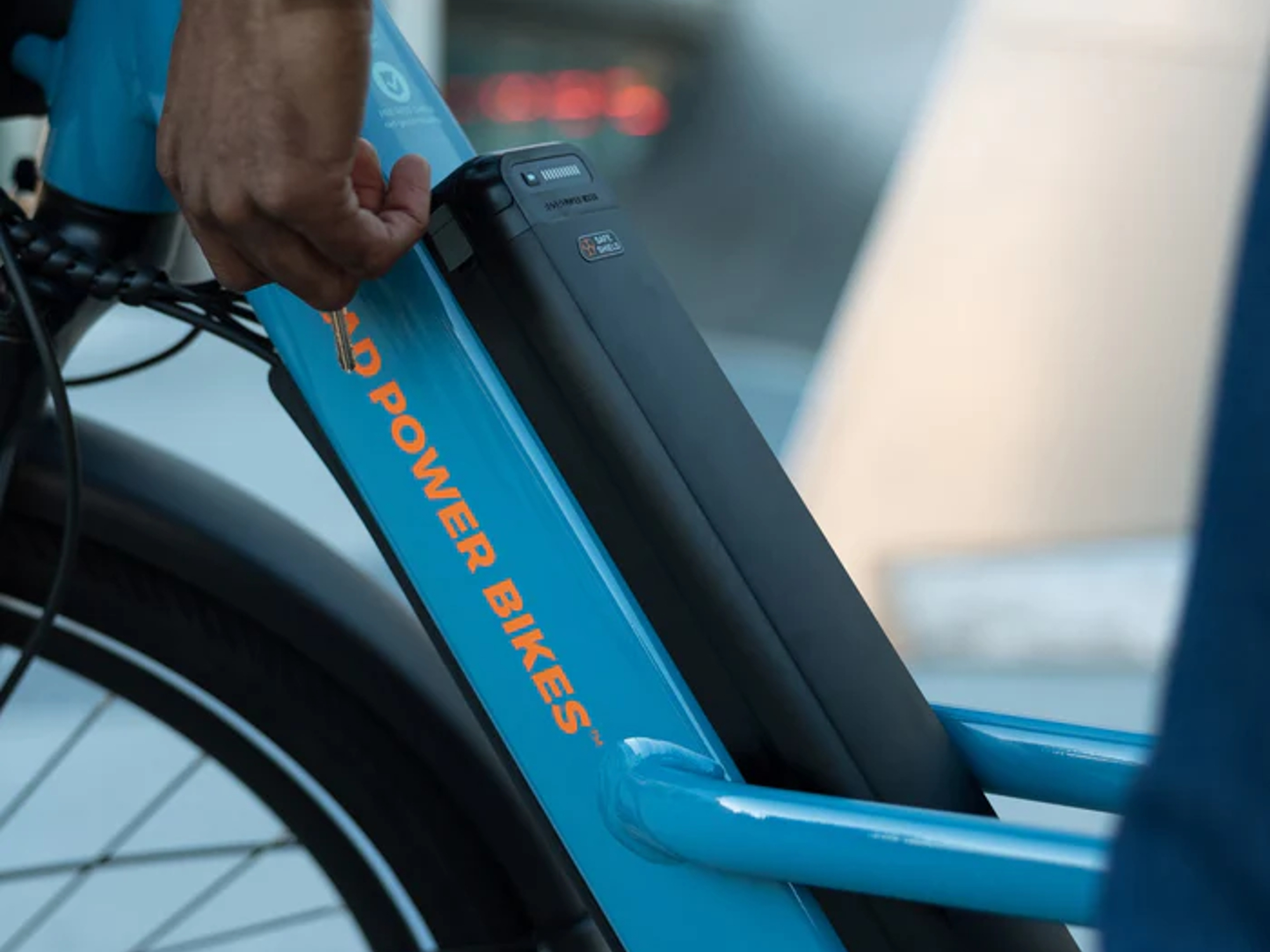 Rad Power Bikes Safe Shield thermal resistant e-bike battery installed on a blue Rad Power Bikes Radster Trail e-bike.