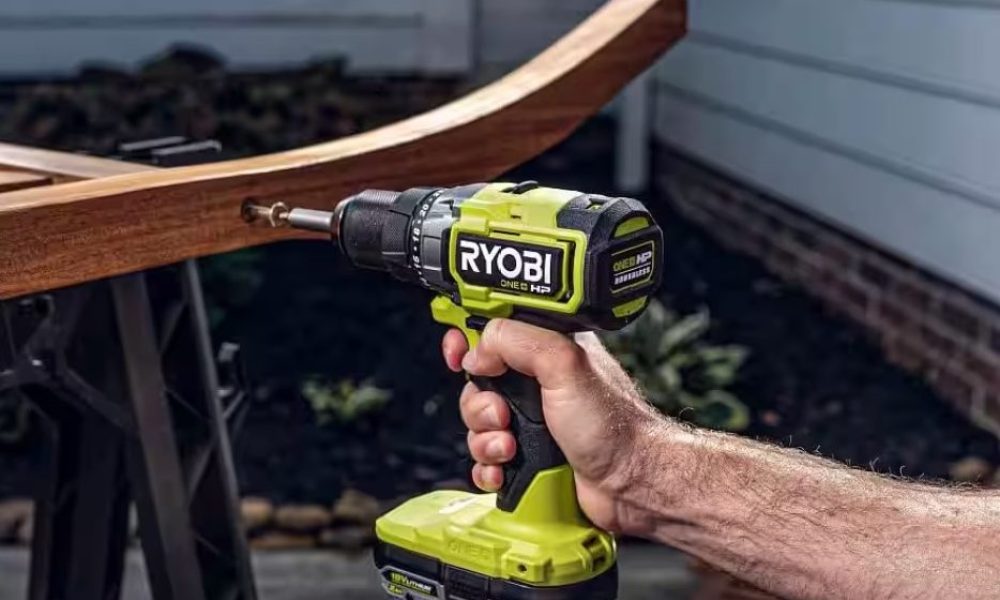 The Ryobi One+ HP Brushless Drill Driver being used one-handed to drill into some wood.