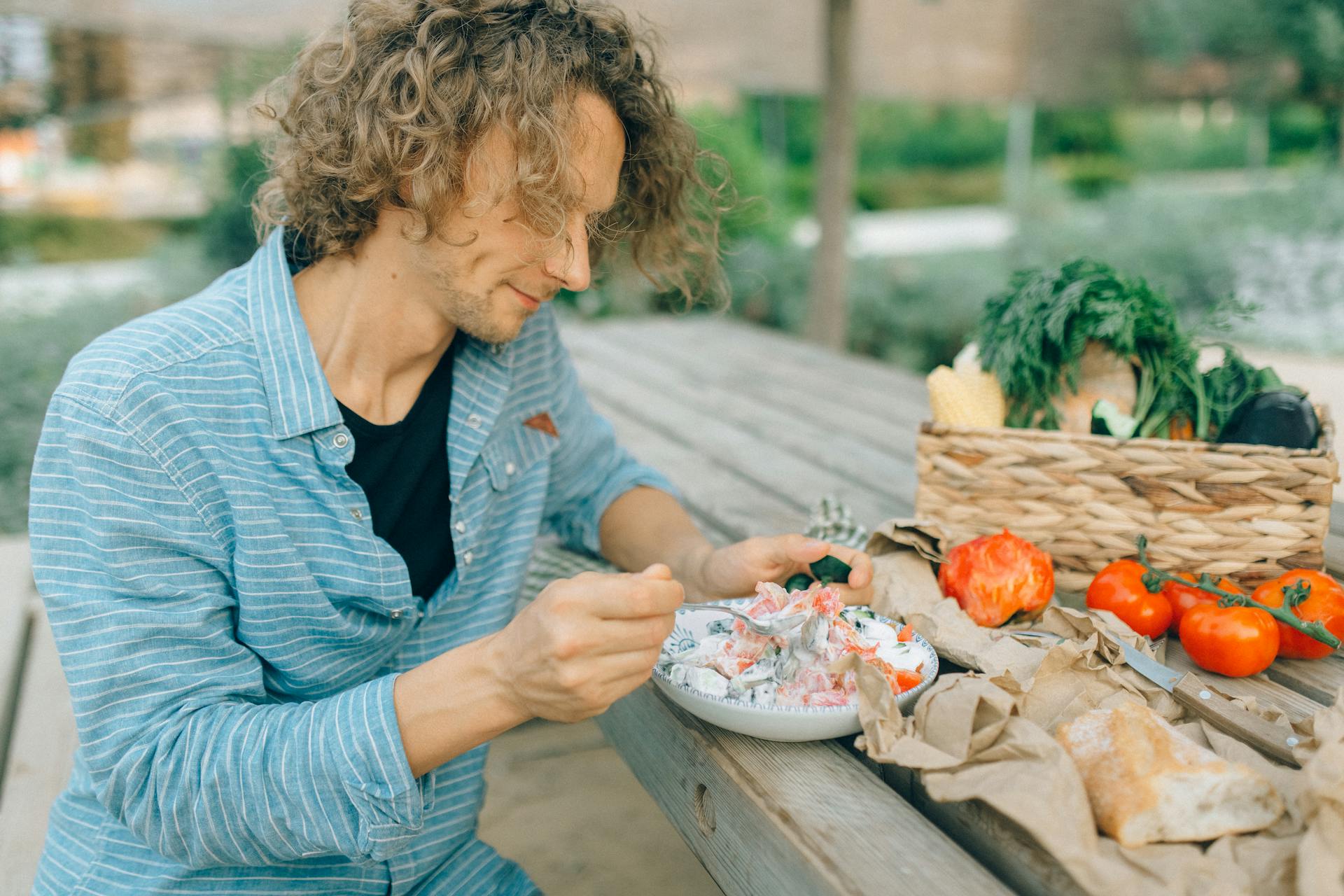 man eating salad at table