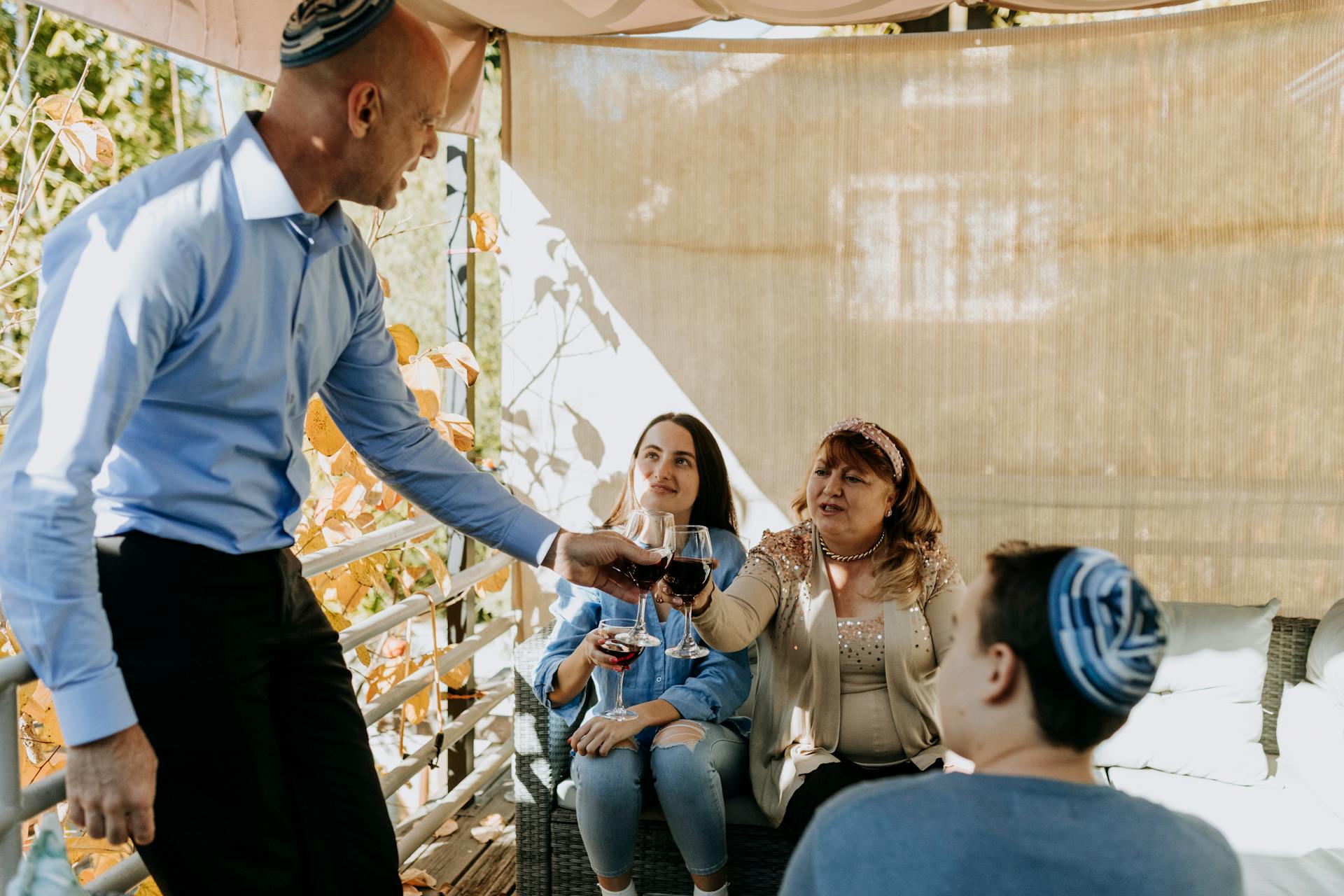 People celebrating Jewish holiday with wine