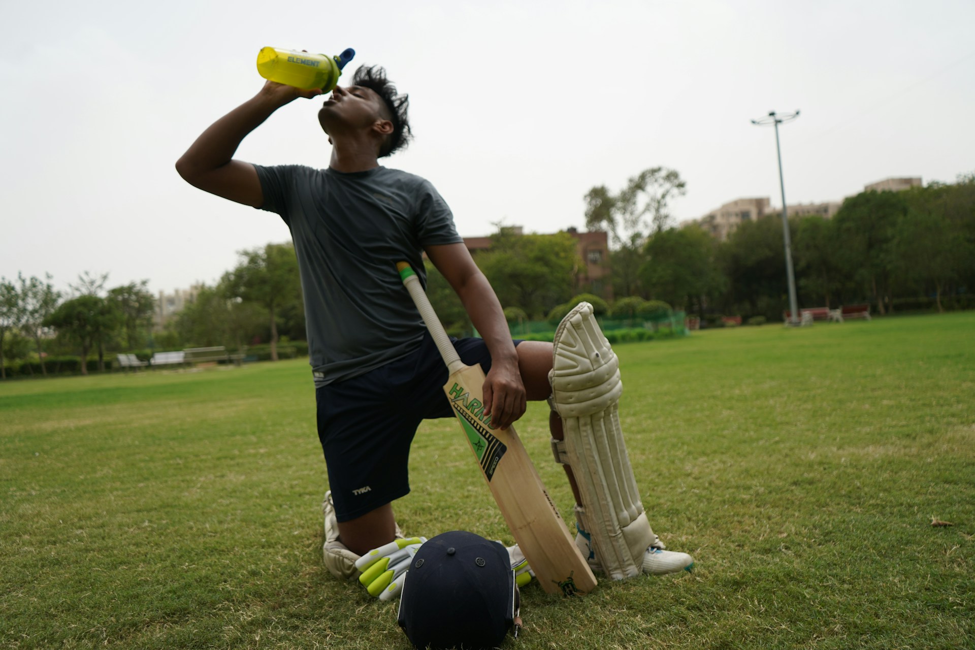 man drinking water while playing sports