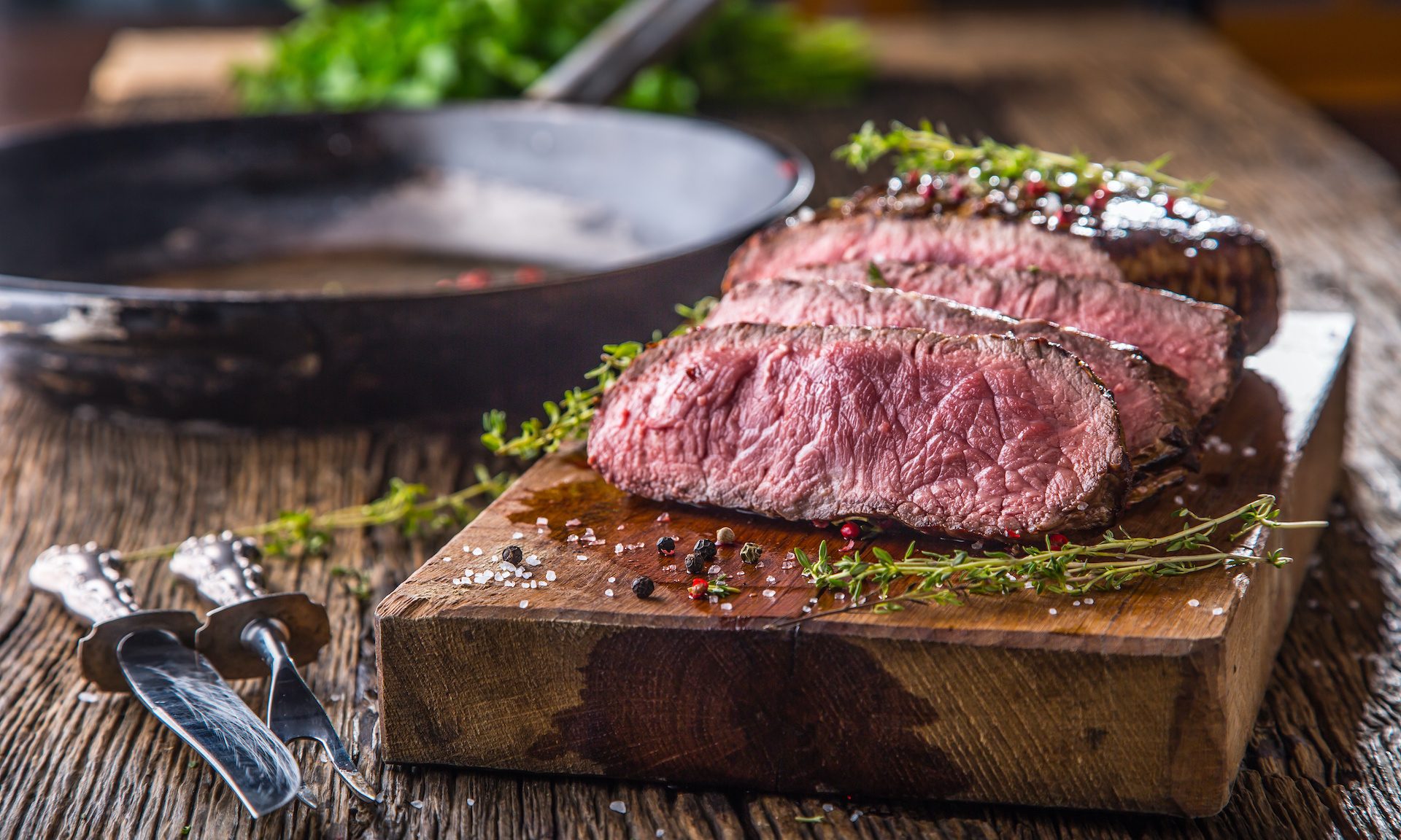 Sliced steak on cutting board