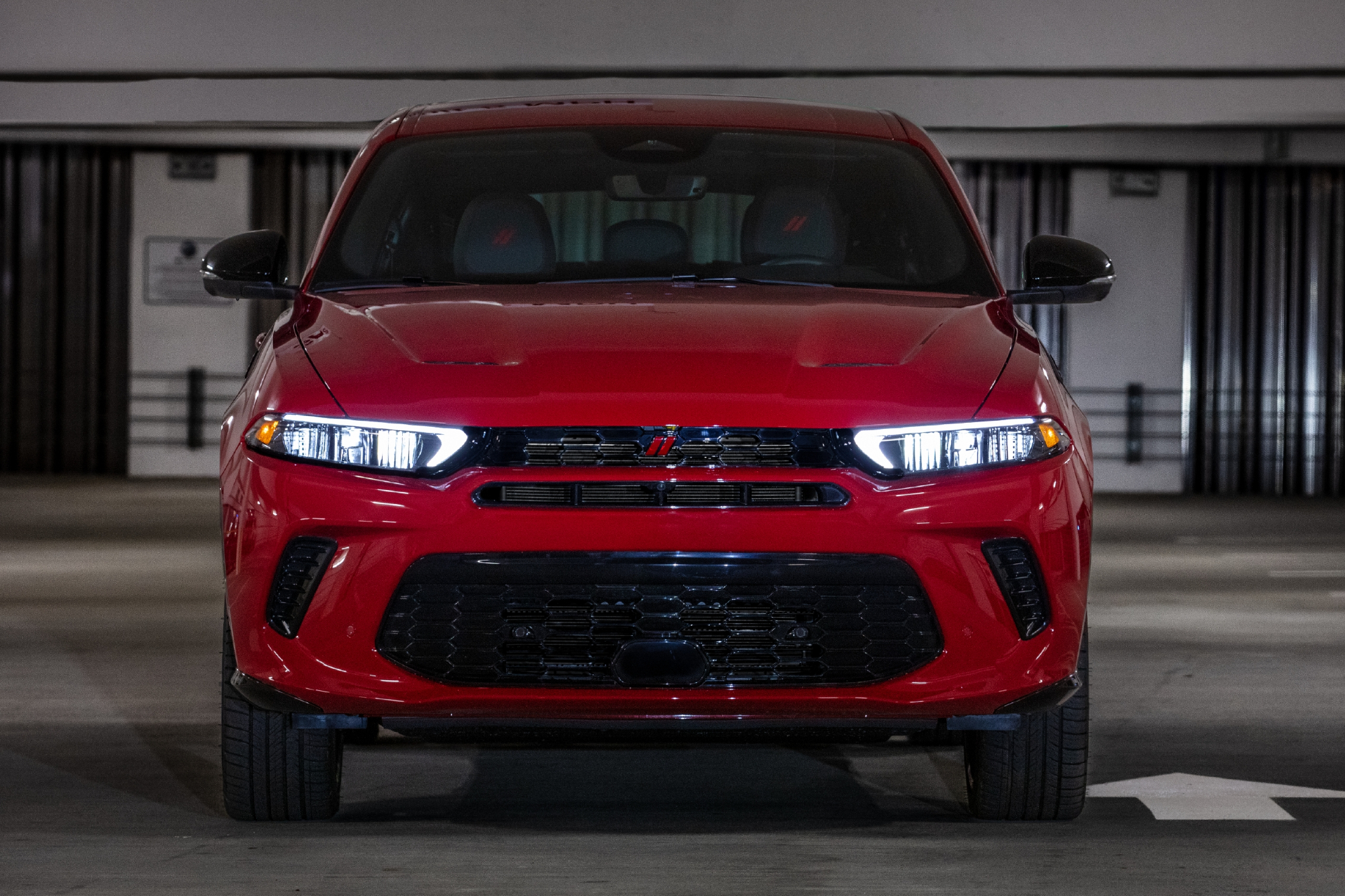 Red 2024 Dodge Hornet RT in a parking garage with a direct front view.