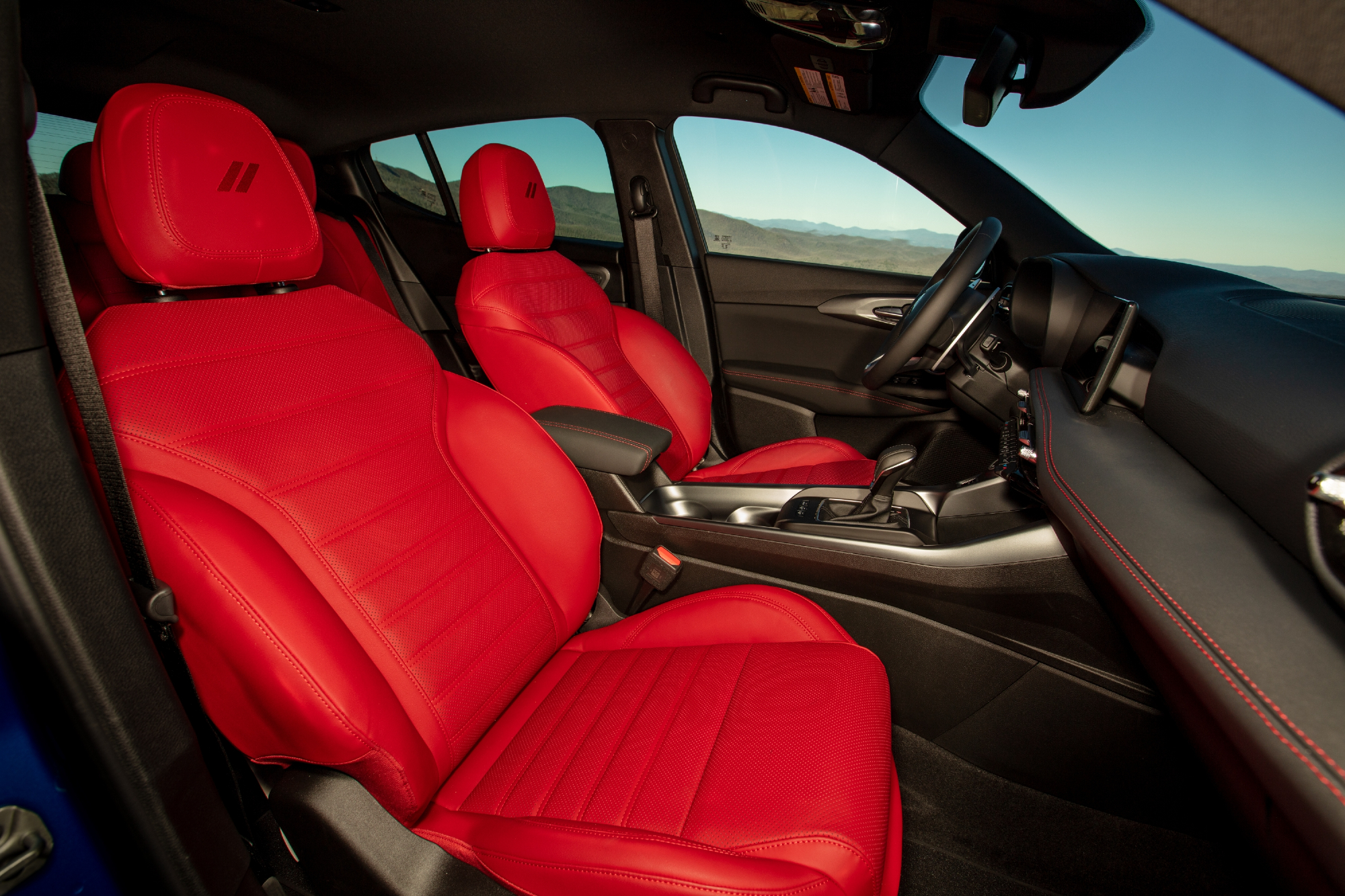 Red 2024 Dodge Hornet RT view of the interior of the car with optional red leather seats taken from the passenger side door.