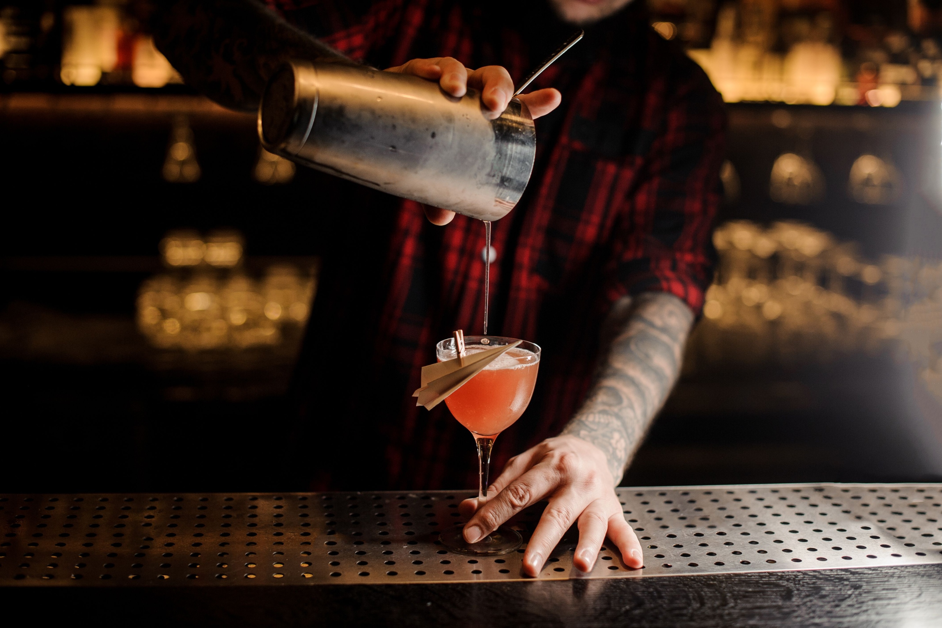 barman pouring paper plane cocktail