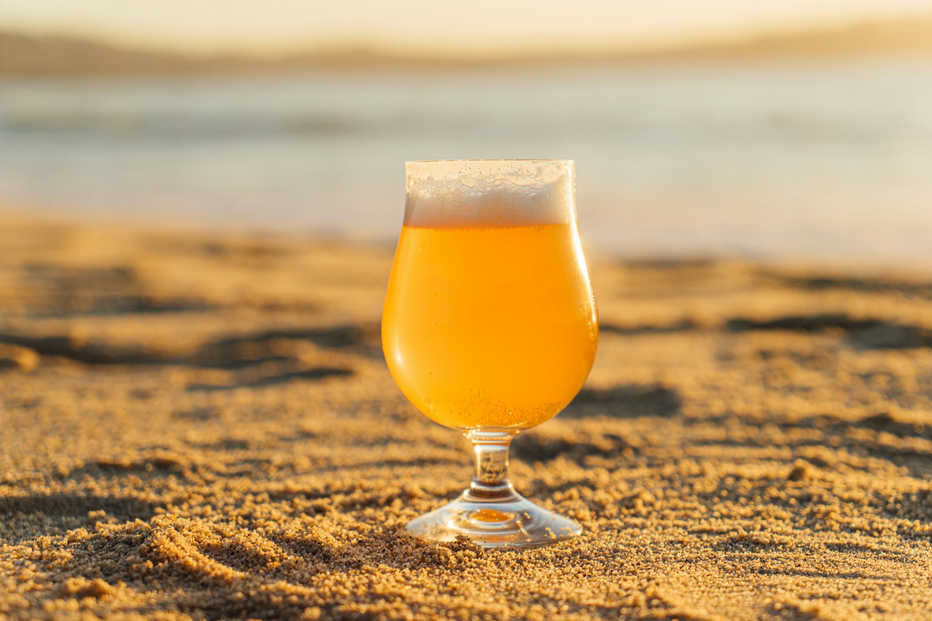 A glass of beer on a beach