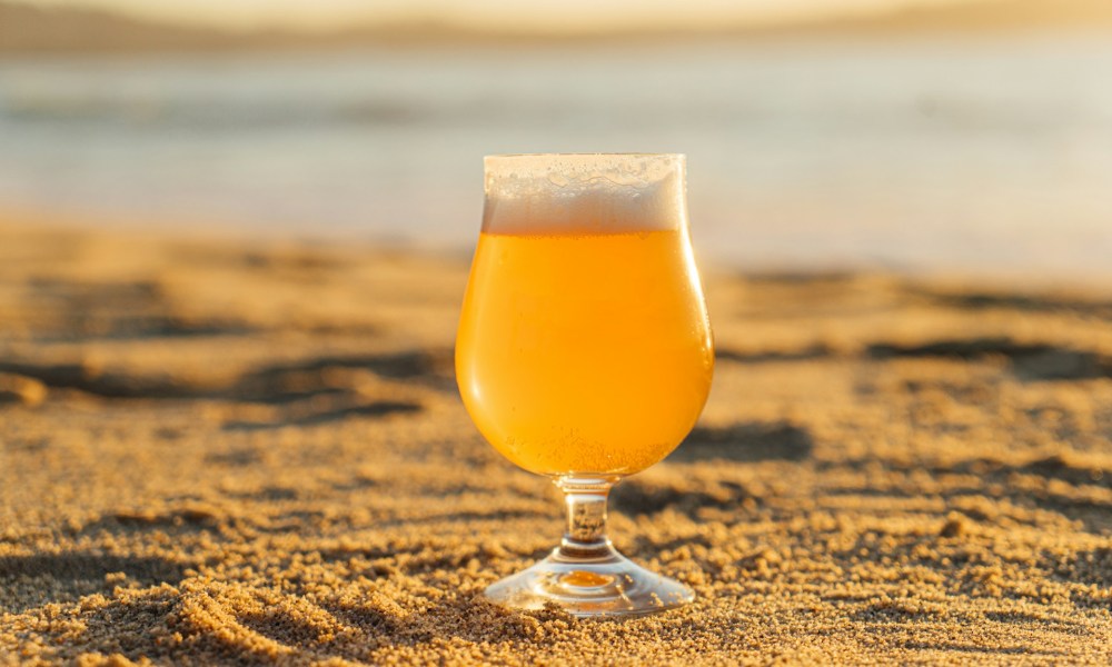 A glass of beer on a beach