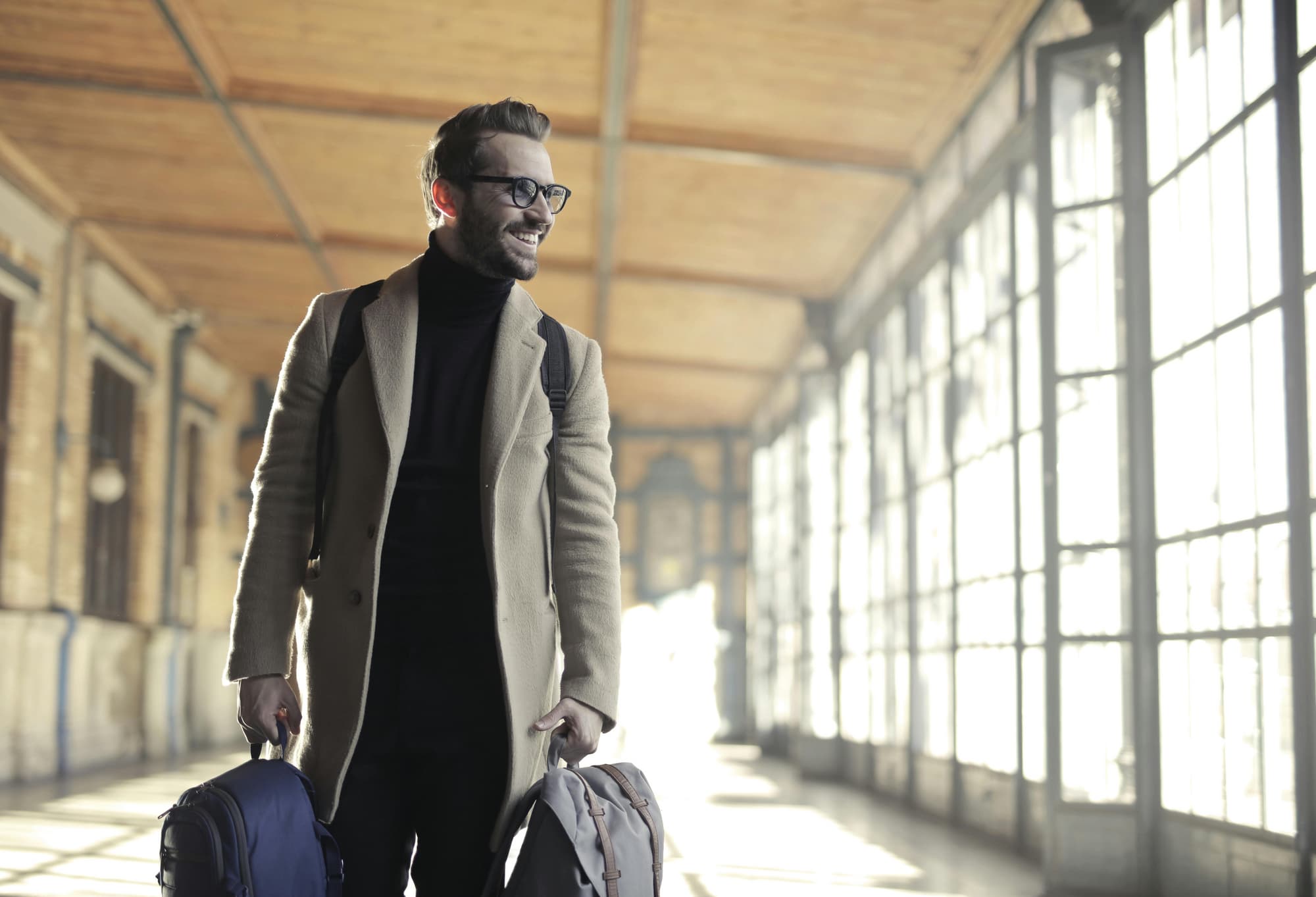 man carrying bag smiling