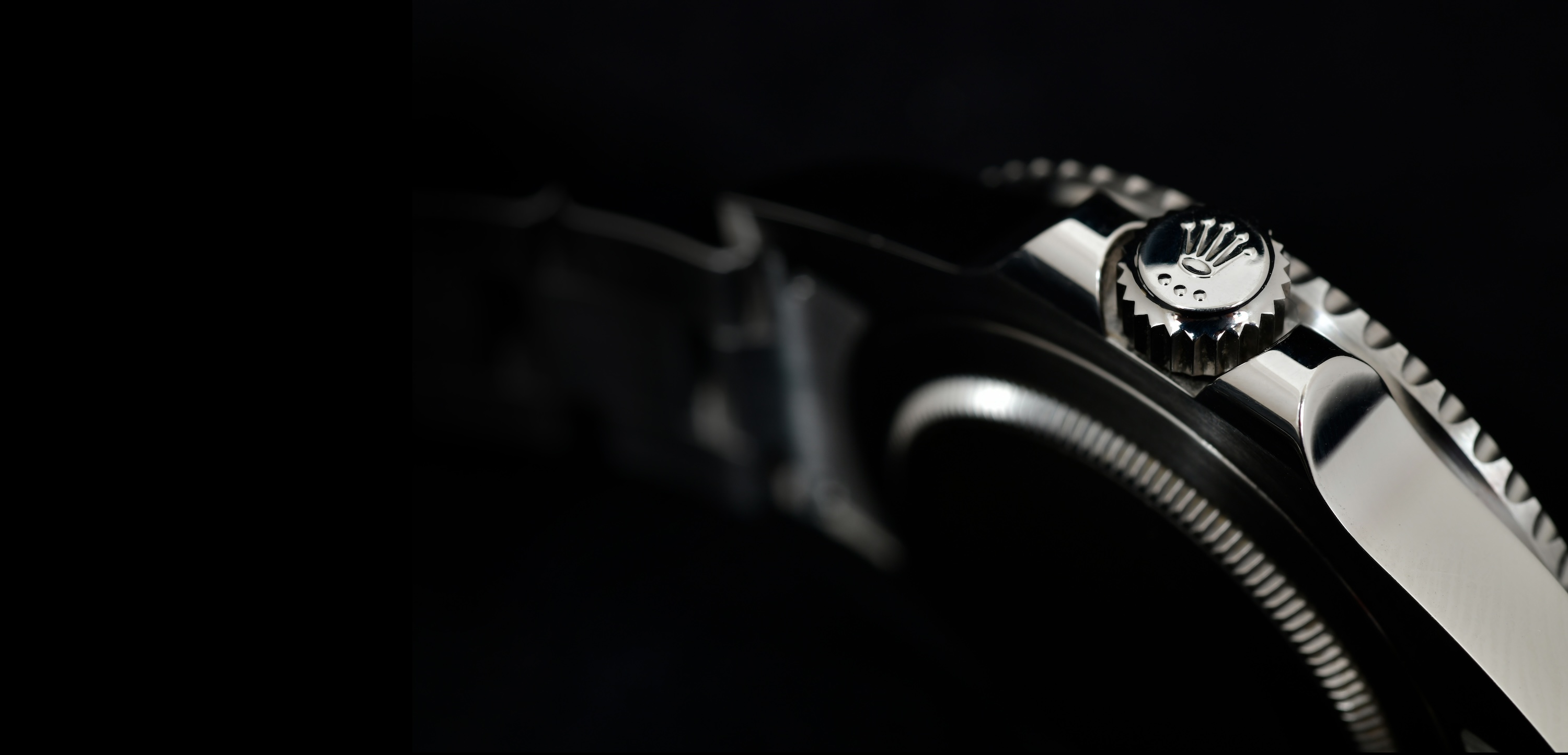 Close-up view of the side of a Rolex watch GMT-Master II "Batman"40mm Steel Ceramic Men's Wrist watch on black background