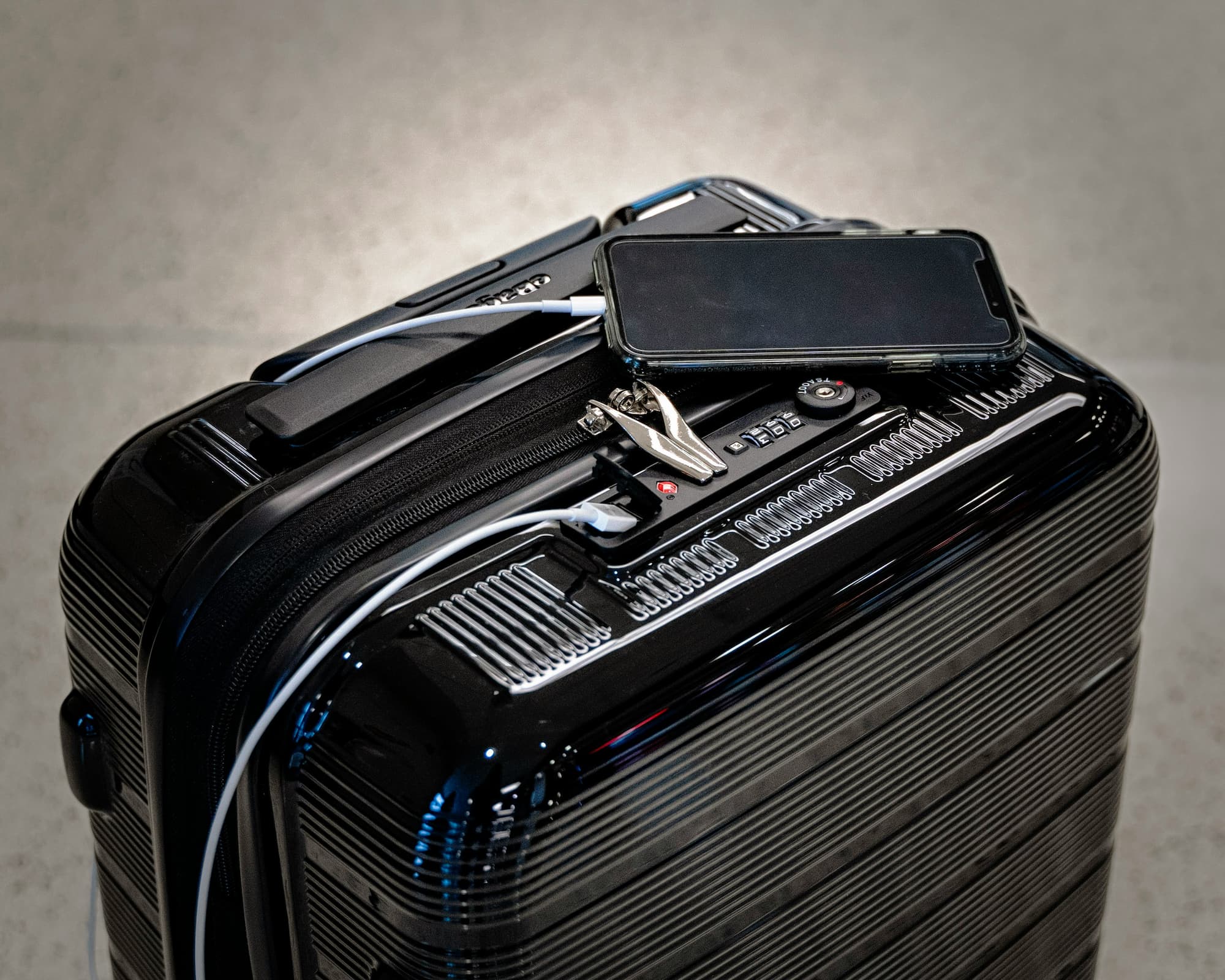 suitcase with phone sitting on top