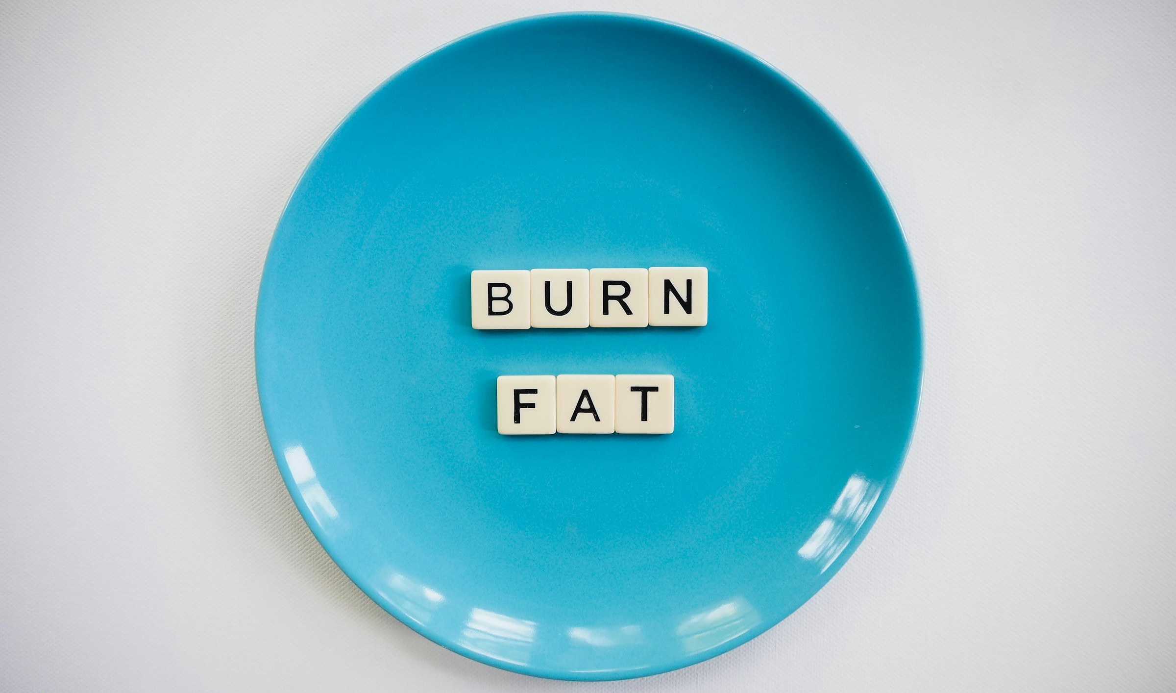 burn fat words on blue plate grey background