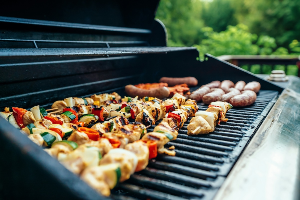 A wide shot of skewers on a grill