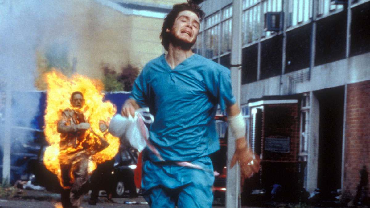 Cillian Murphy runs from a zombie on fire in 28 Days Later.