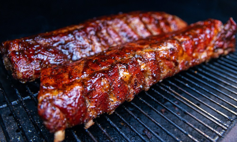 Babyback ribs cooking on a grill