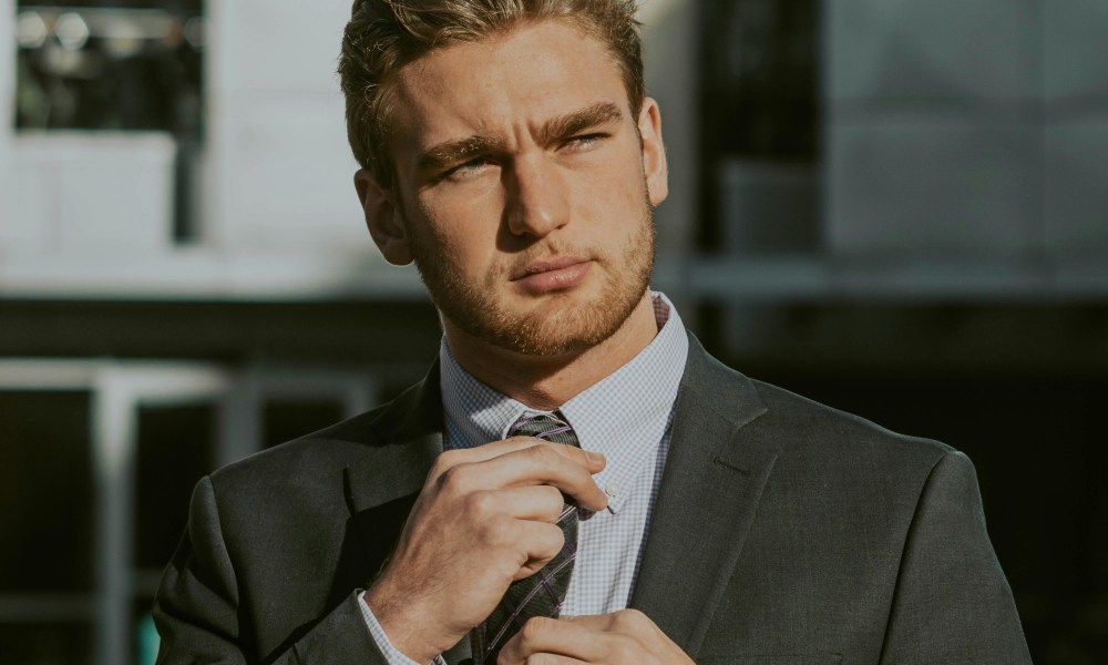 Man adjusting his tie