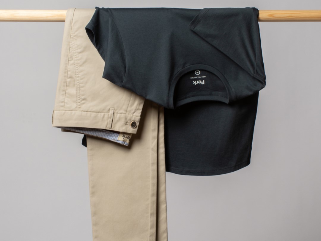 Perk clothing with polo and pants hung up