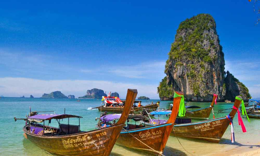 five brown wooden boats in Thailand