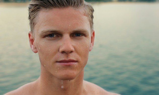 closeup of man with wet face standing by water