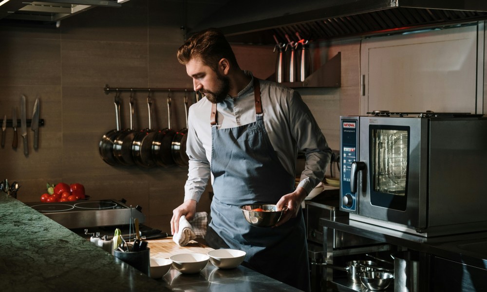 Man with apron in industrial kitchen