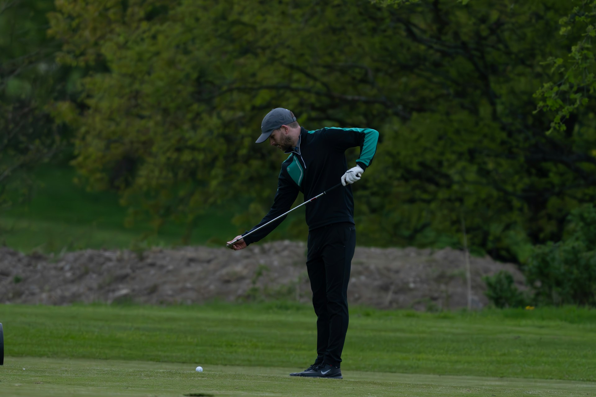 man golfing wearing jacket