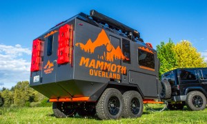 Mammoth Overland TL Travel Trailer being towed by a black Jeep Wrangler.