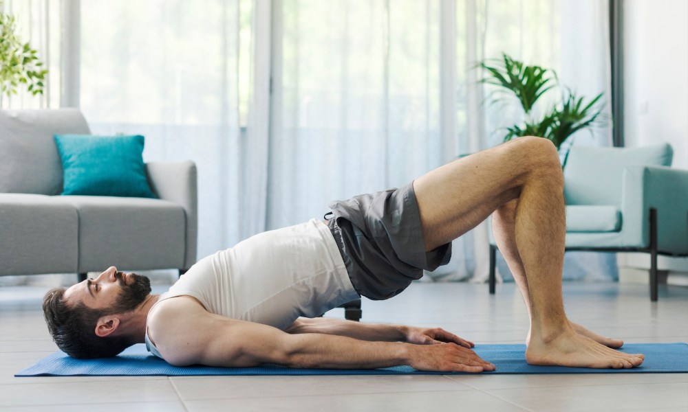 Man doing a glute bridge at home