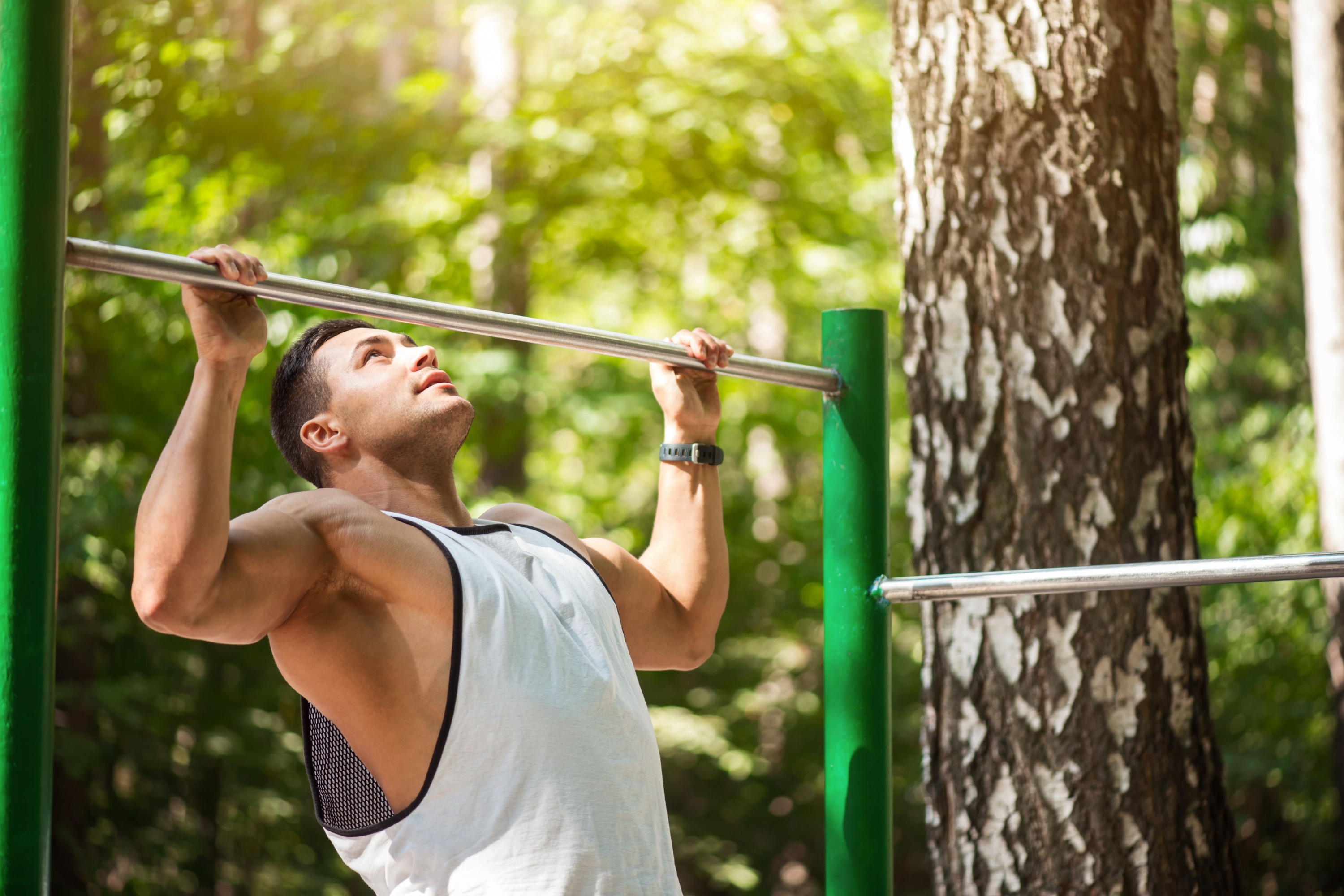 hard working man doing chin ups