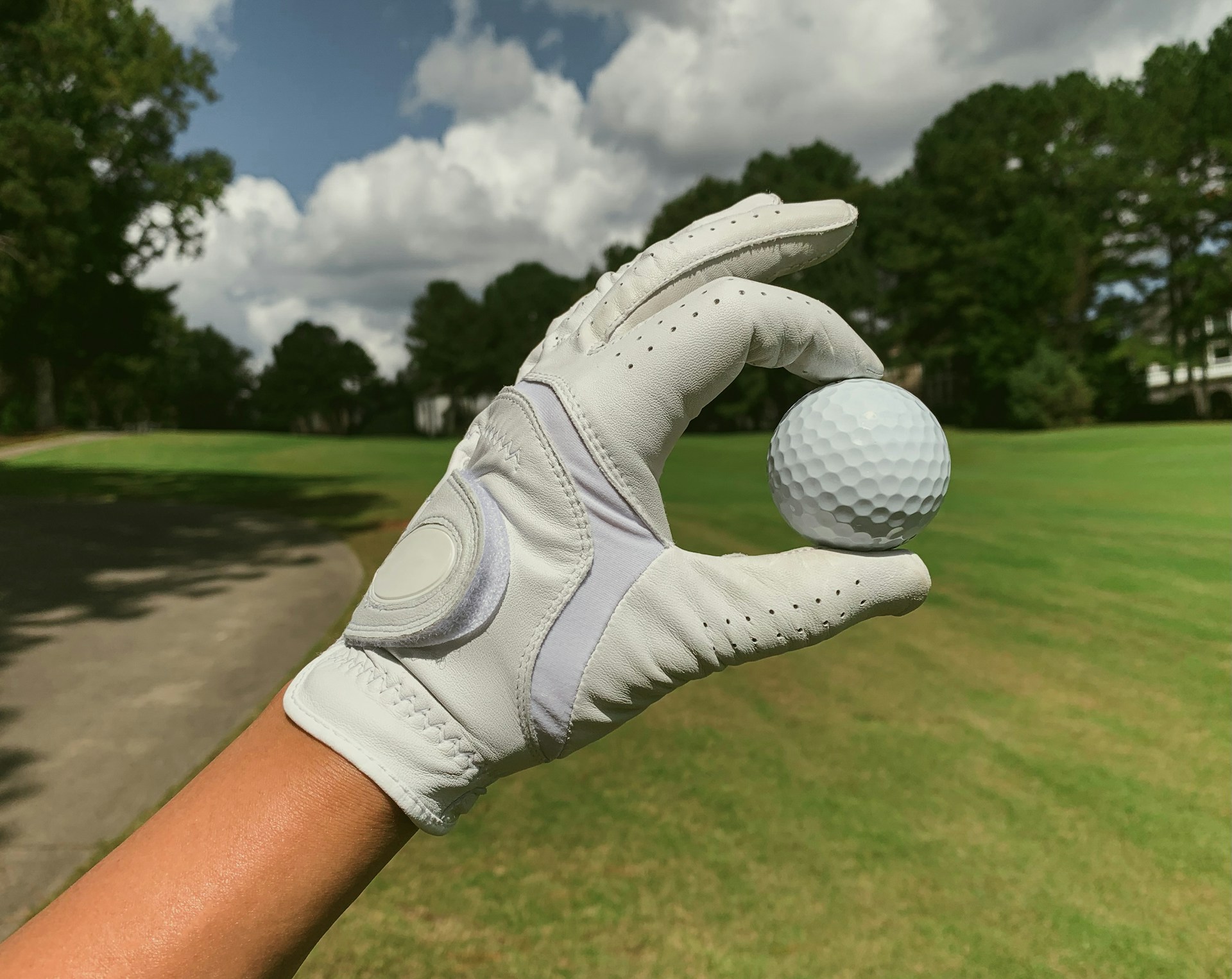 man wearing golf glove holding a golf ball