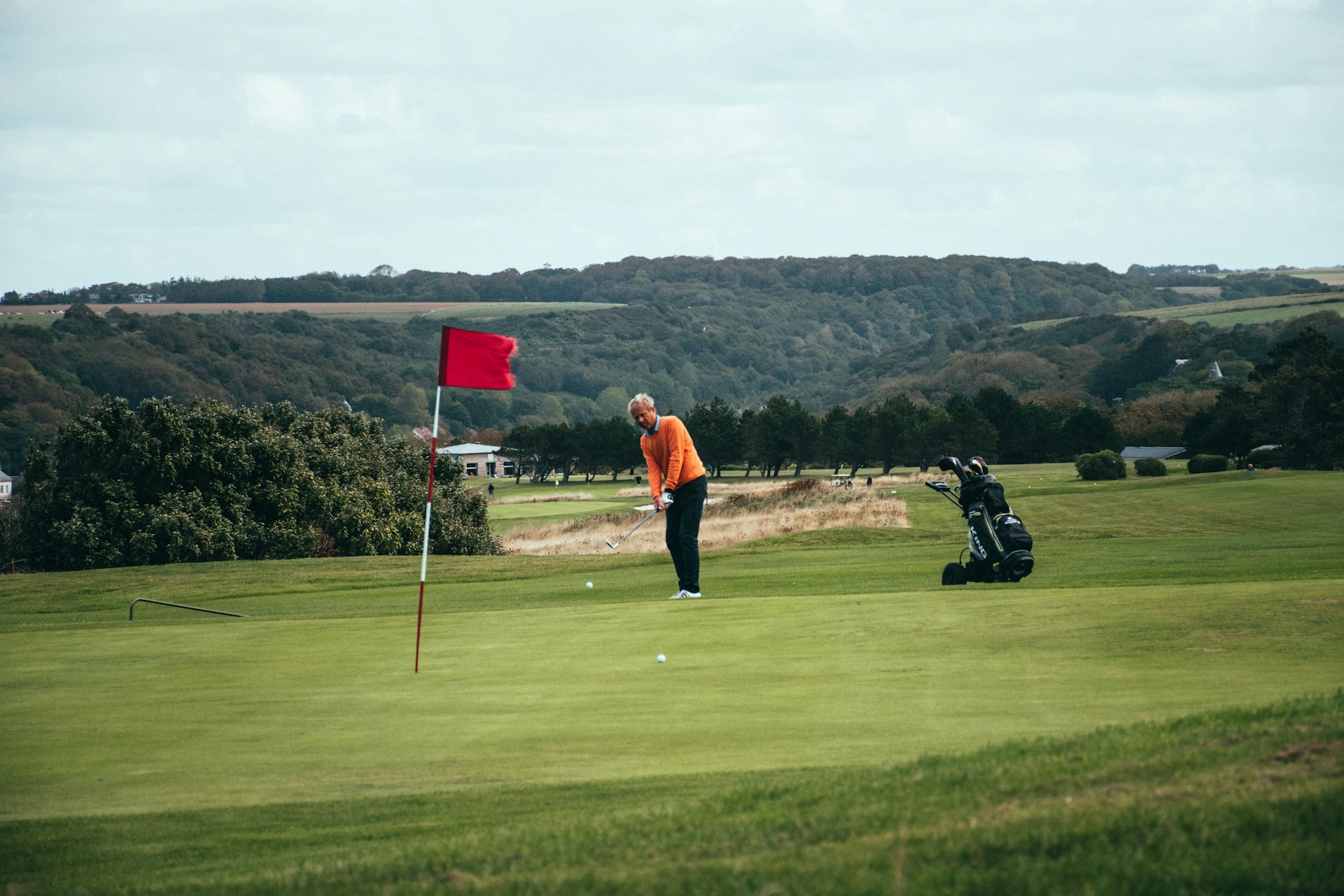 A person making a shot on a golf course in France.