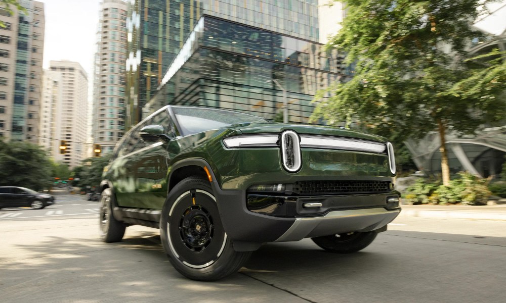 Second-generation Rivian R1S right front three-quarter view parked on a city street.