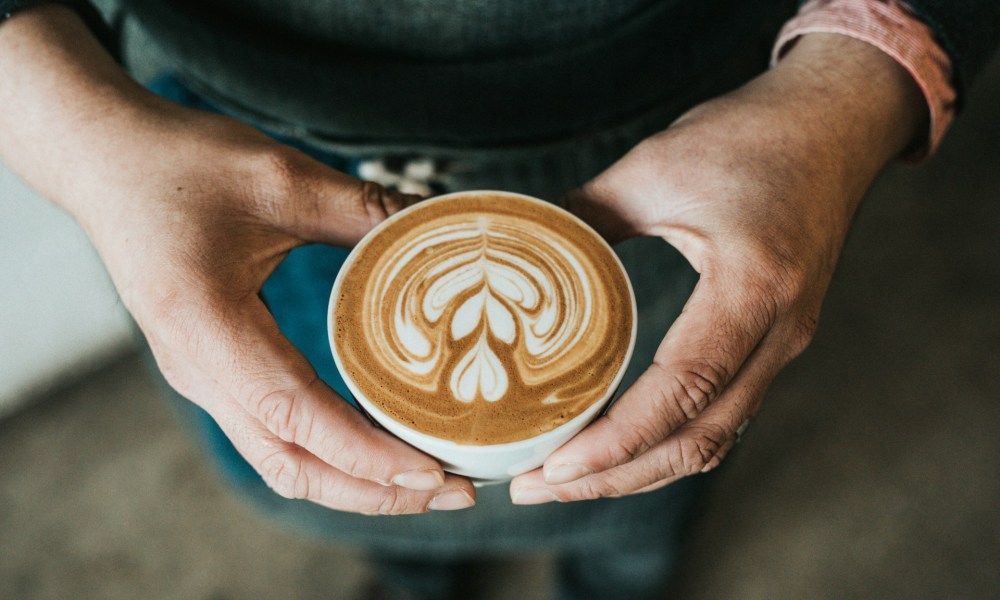 man holding cup of coffee