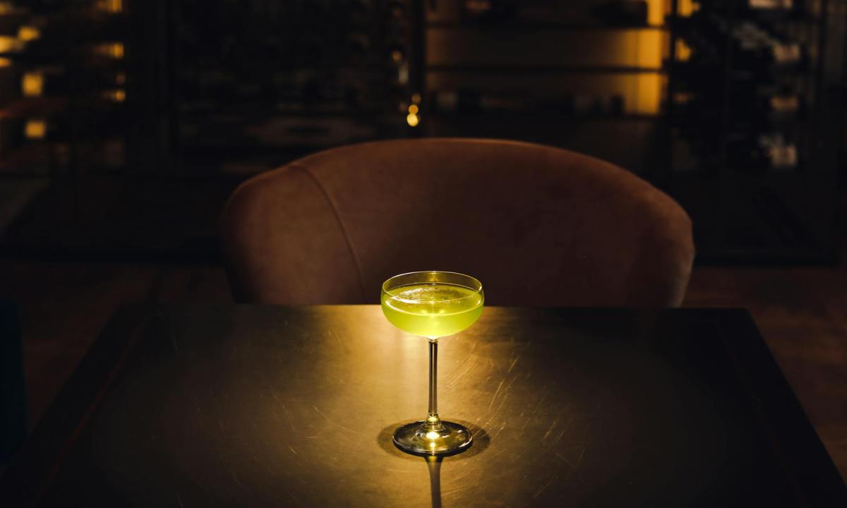 Dark bar with a backlit cocktail on table