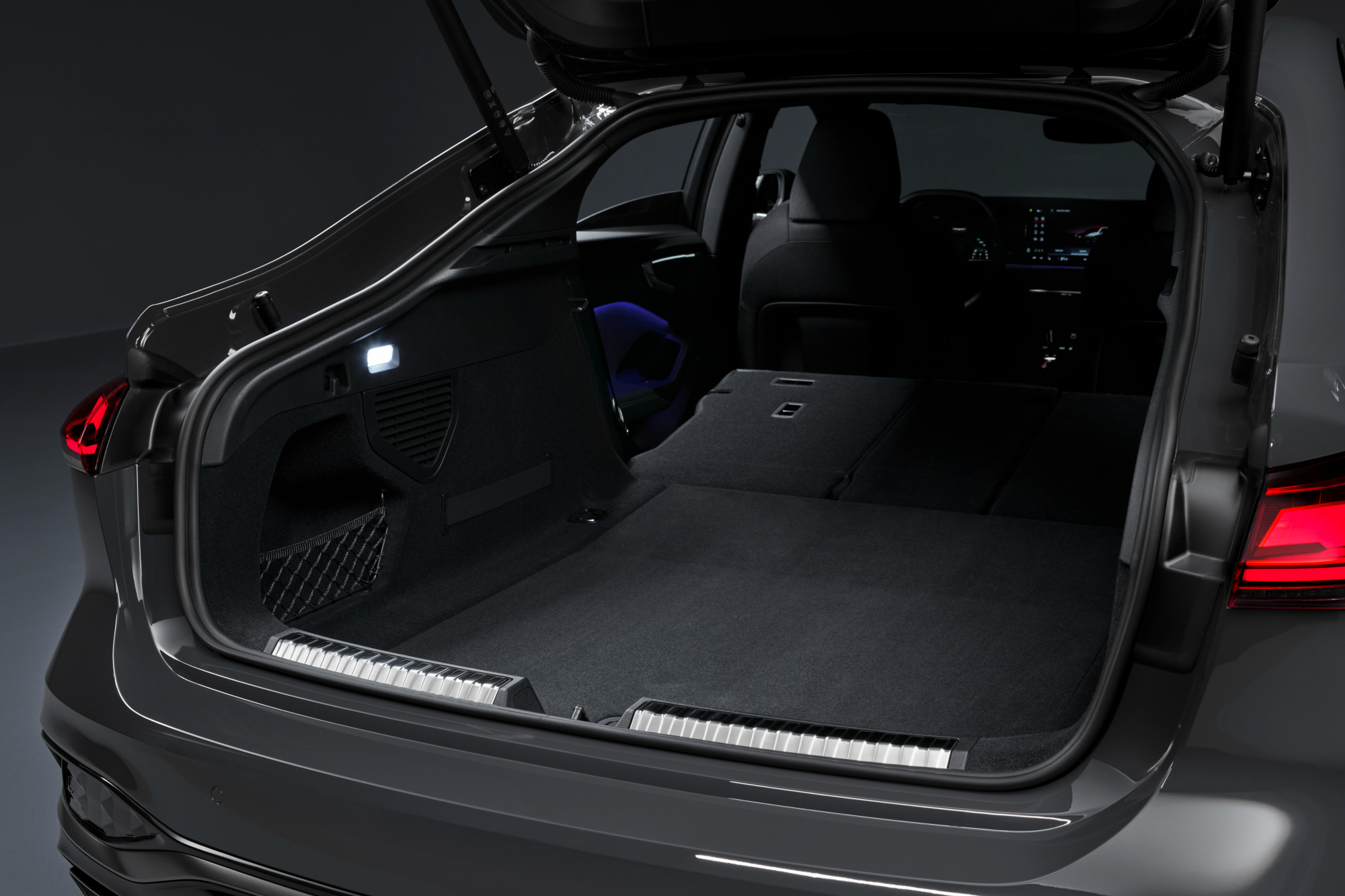 2025 Audi A5 interior shot of the cargo area with second row seats folded forward.