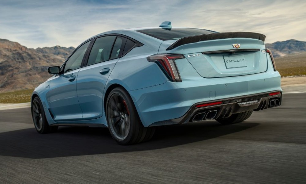 2025 Cadillace CT5-V Blackwing luxury sport sedan on the highway with hills and mountains in the background.