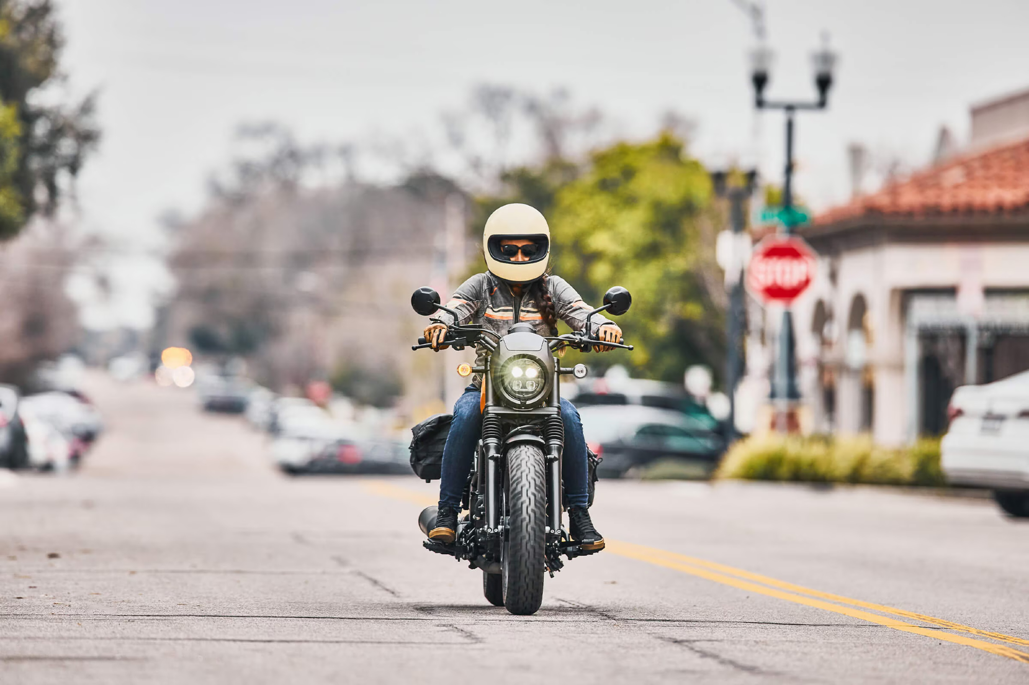 Honda Rebel 300 with rider on a city street direct frontal view.