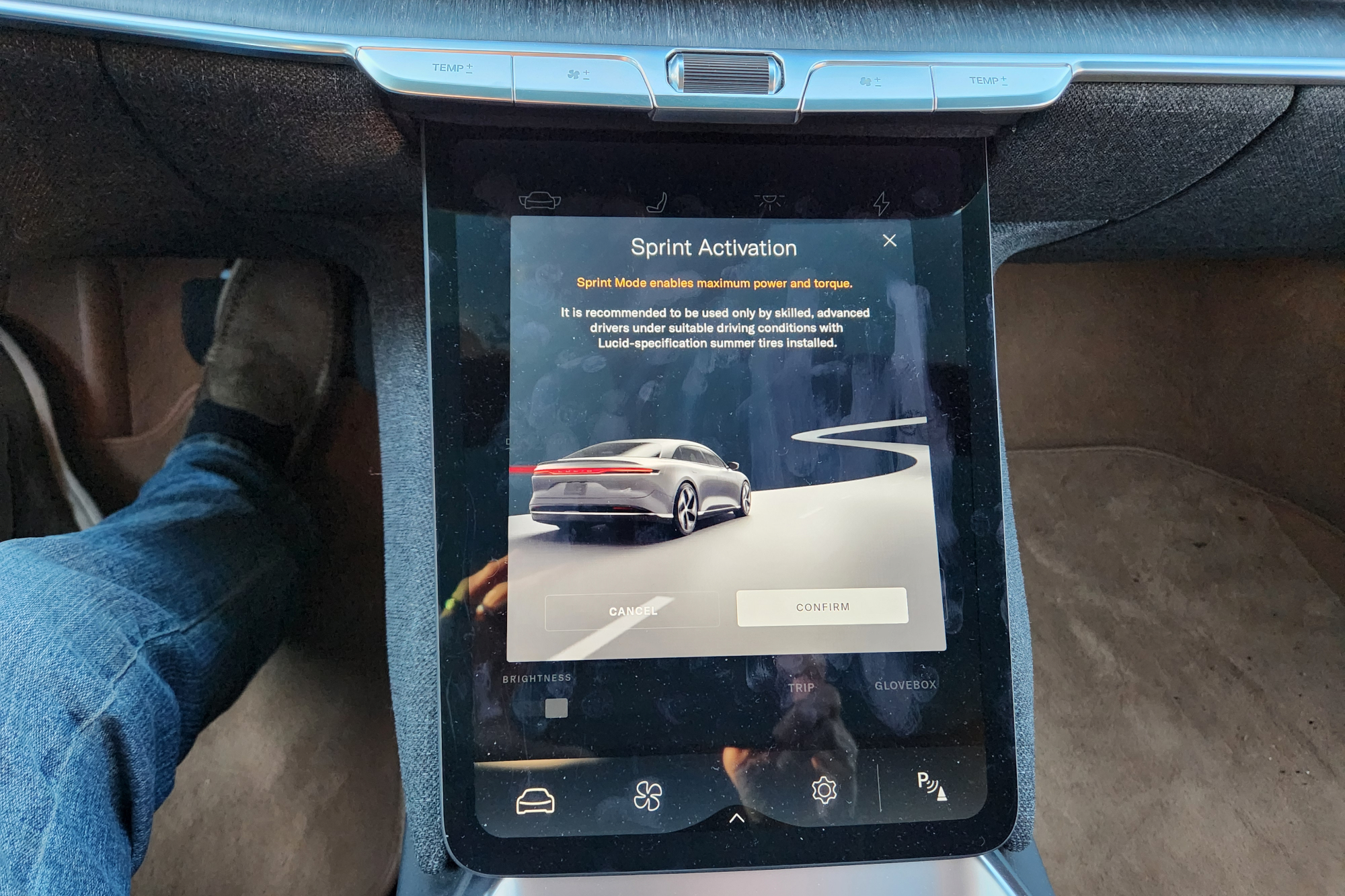 Lucid Air Touring EV switching to Sprint mode with a screenfull of disclaimers and disclosures.