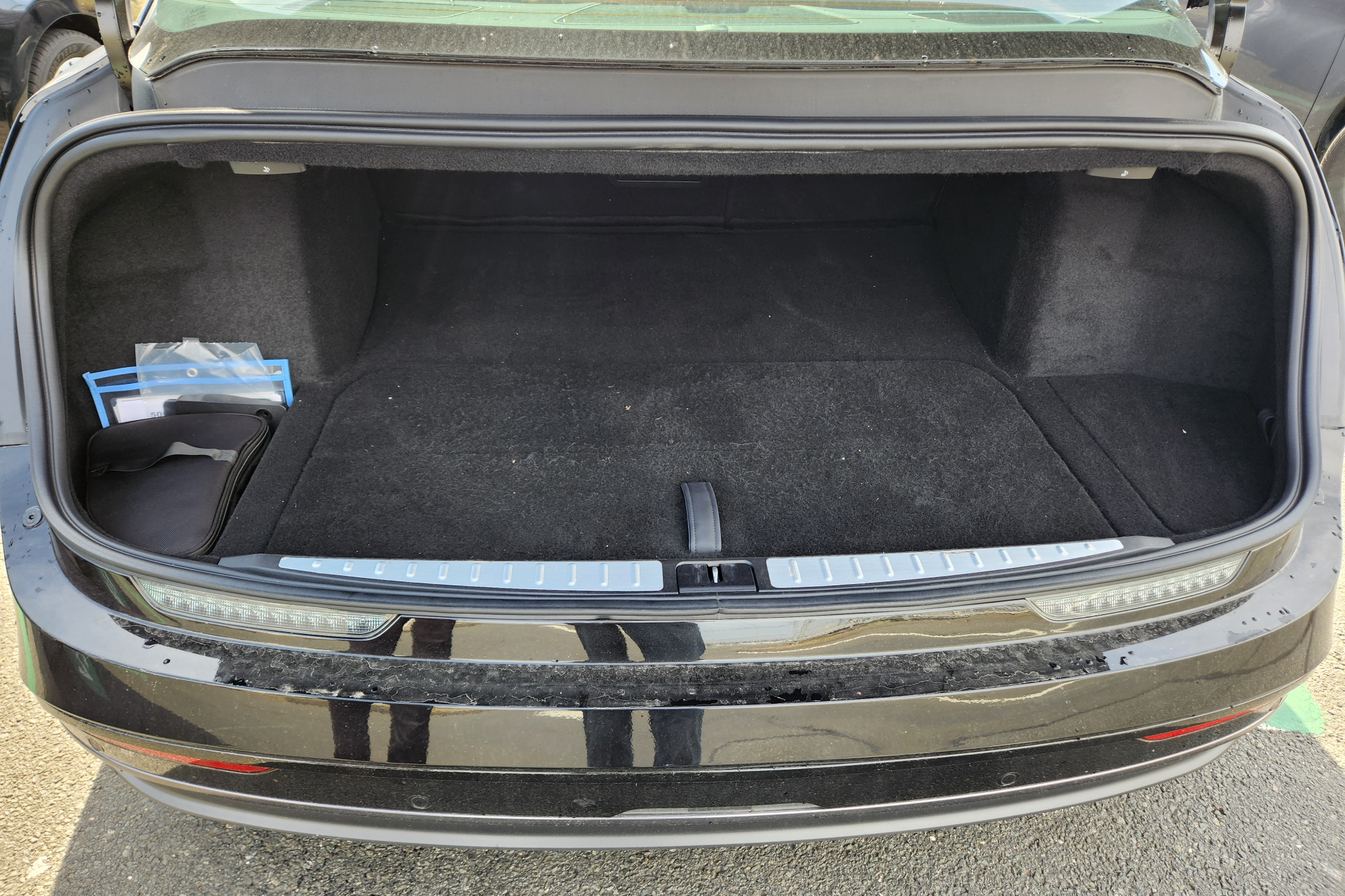 Lucid Air Touring spacious trunk with underfloor storage for charging cable and adapters.