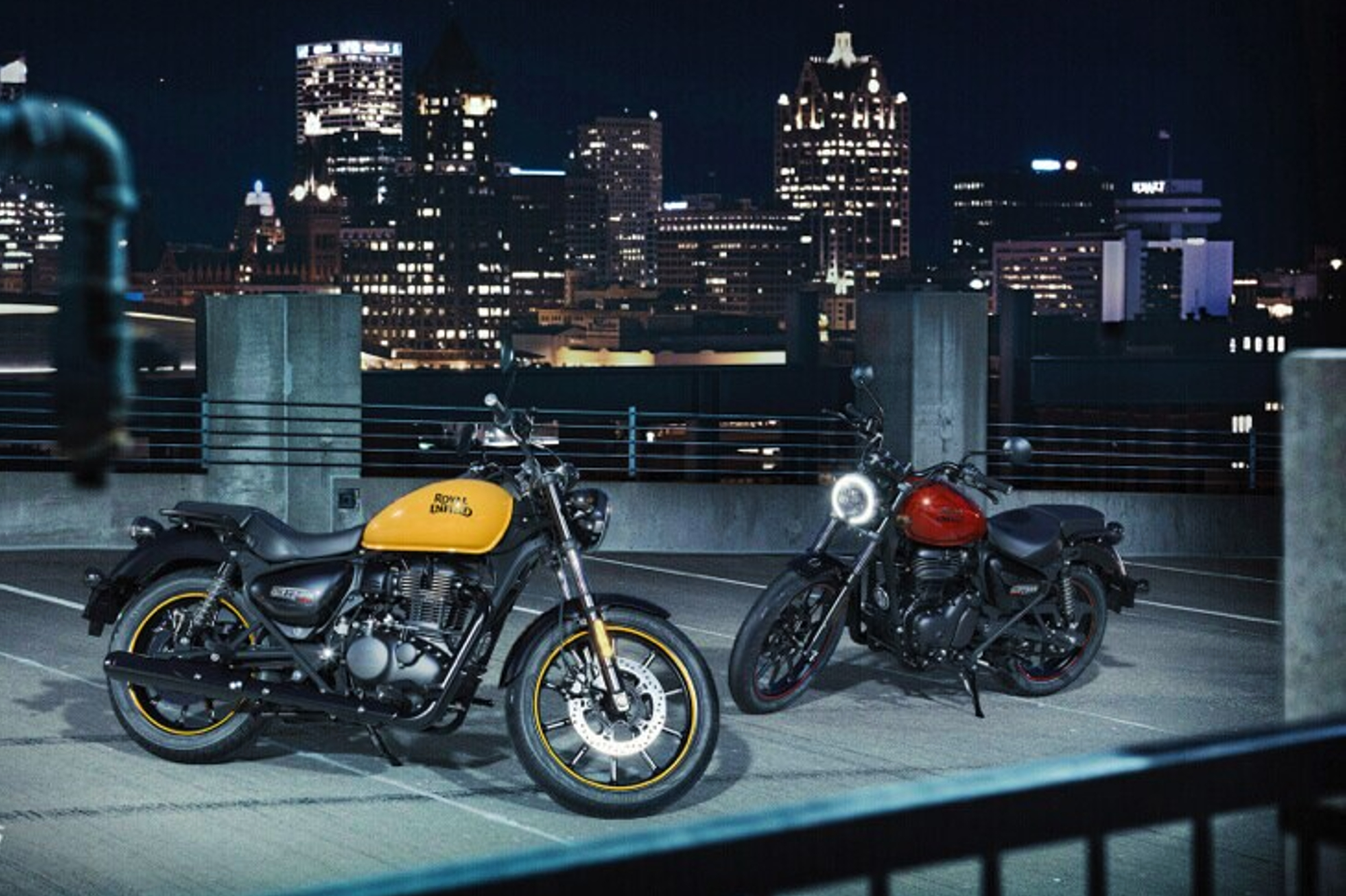 Two Royal Enfield Meteor 350s parked on a building rooftop.