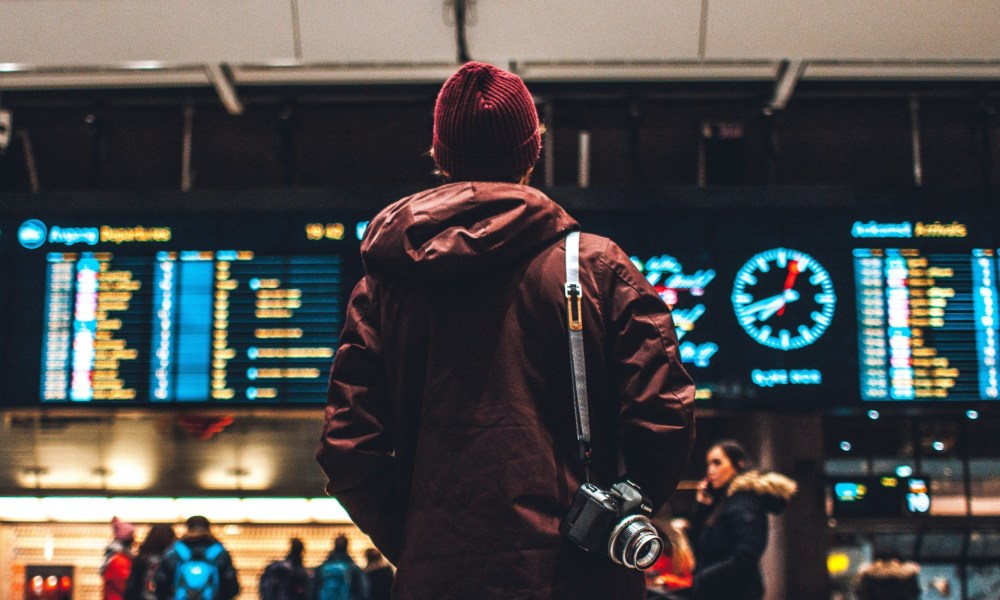 Passenger at airport flight board