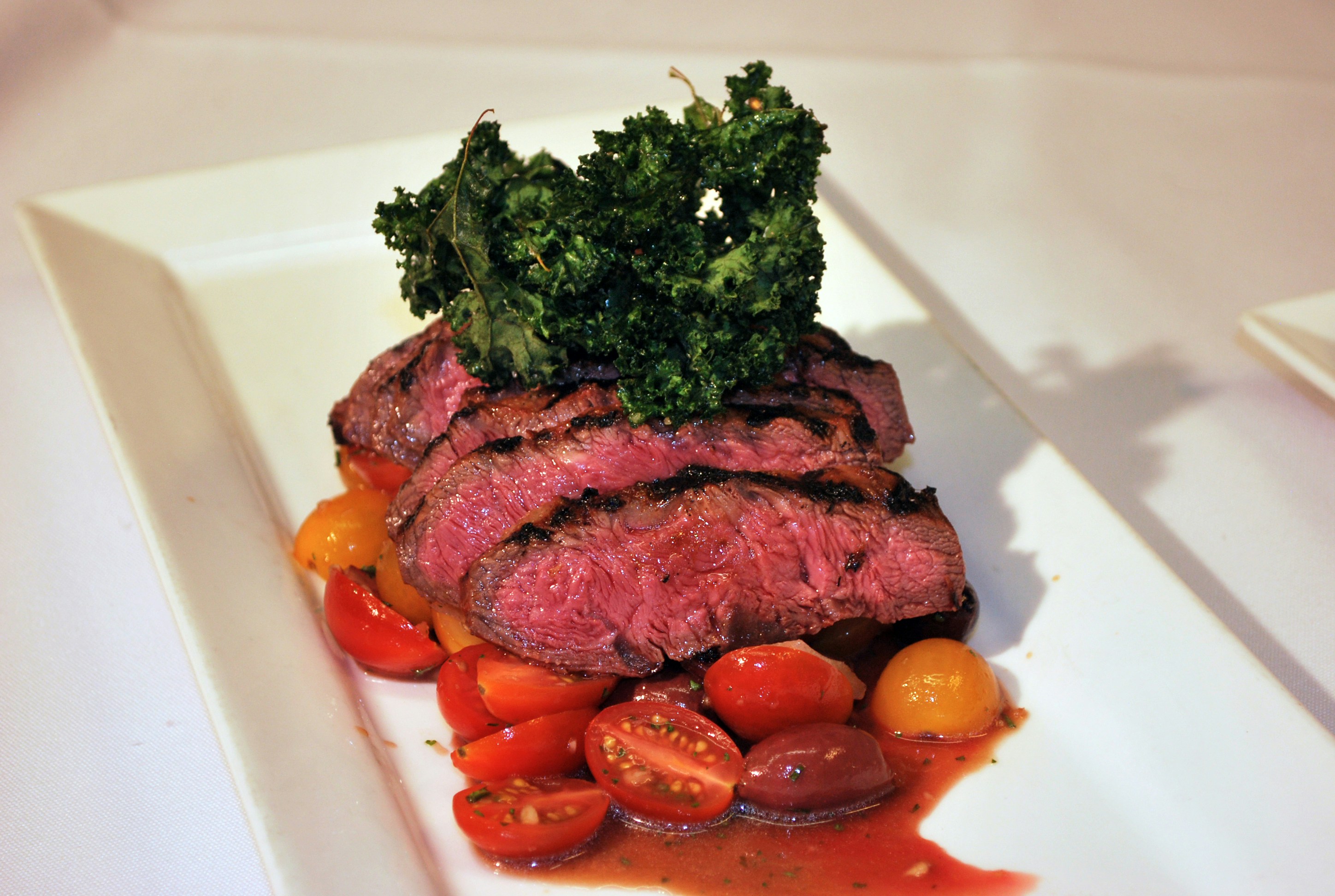 Sliced steak on a white plate