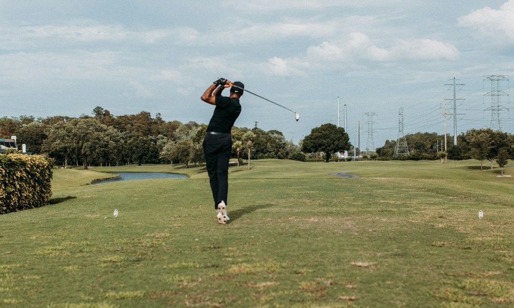 A golfer taking a swing on the golf course.