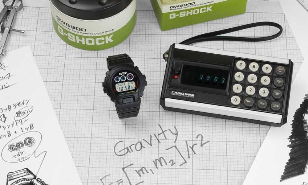 Casio watch on desk with equations and packaging