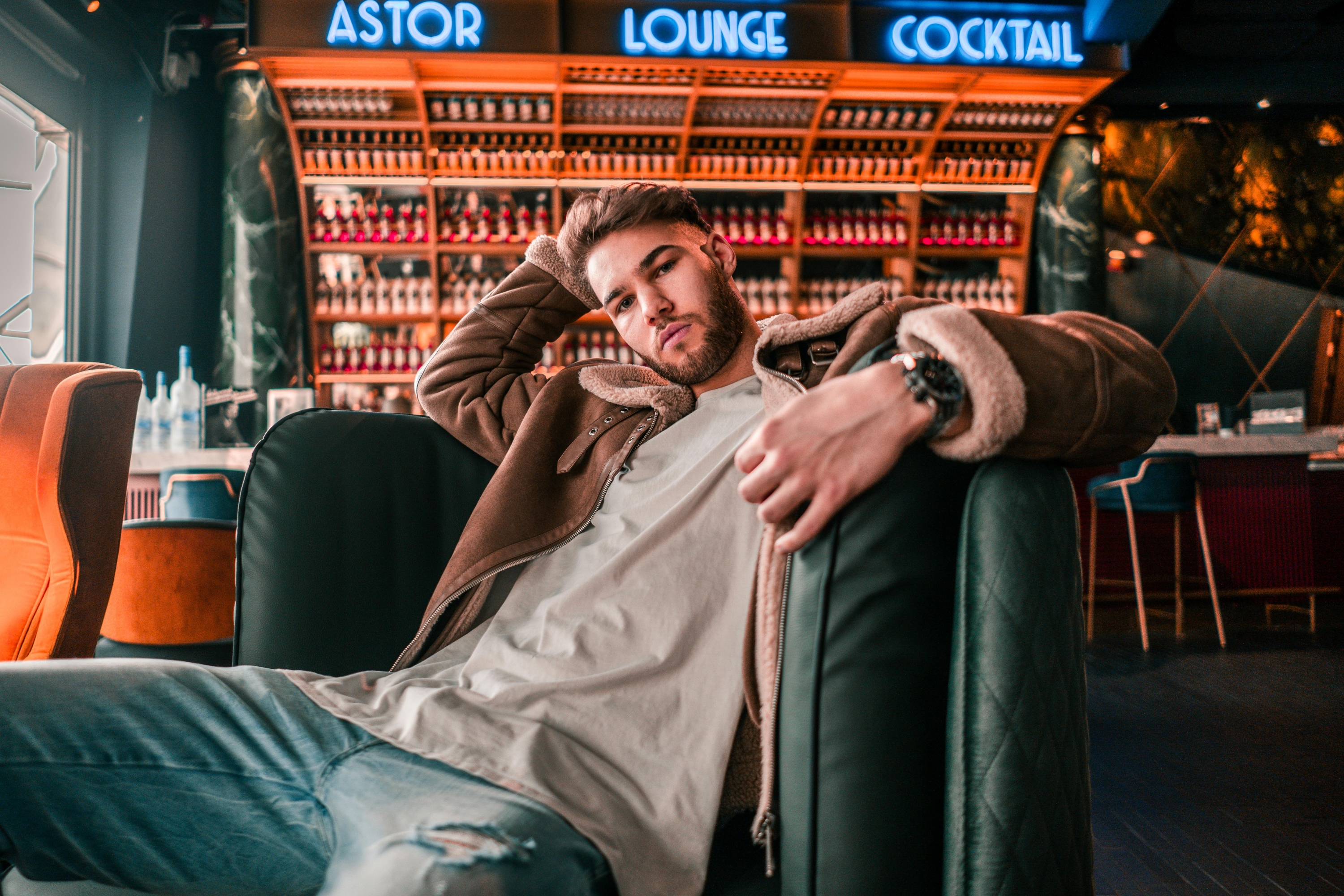 Man on a couch in a leather jacket