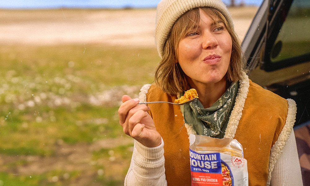 Mountain House backpacker meal with woman smiling