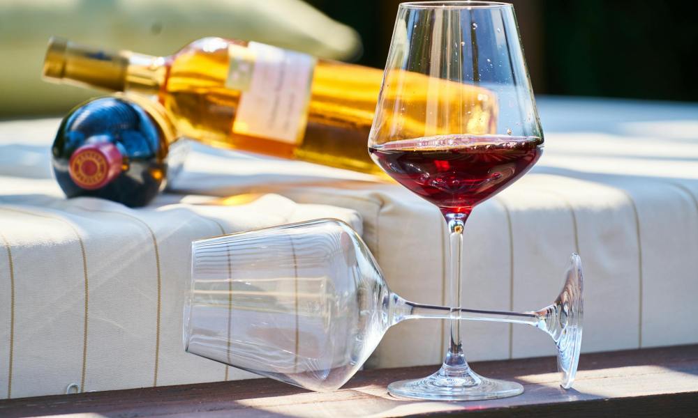 Two glasses of wine on picnic table