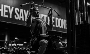 Man doing lat pulldowns black and white close grip